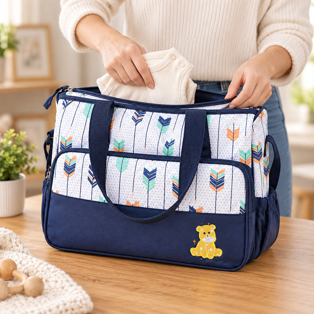 Adult packing a folded cream outfit into the large Starling tote