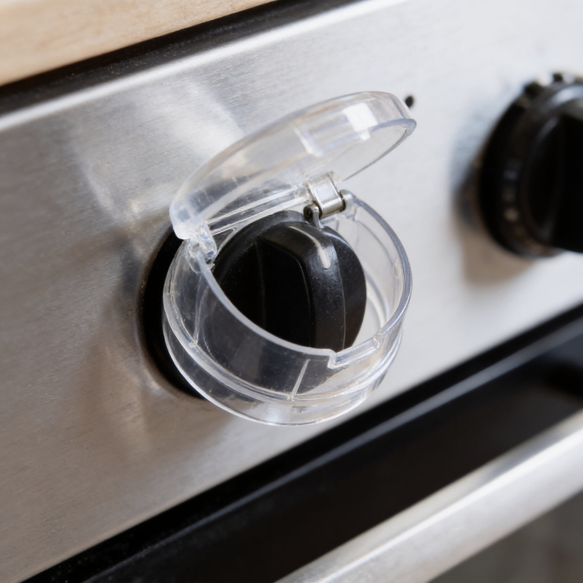 Lumiwee Stove knob covers: close-up of a clear cover with its hinged lid open