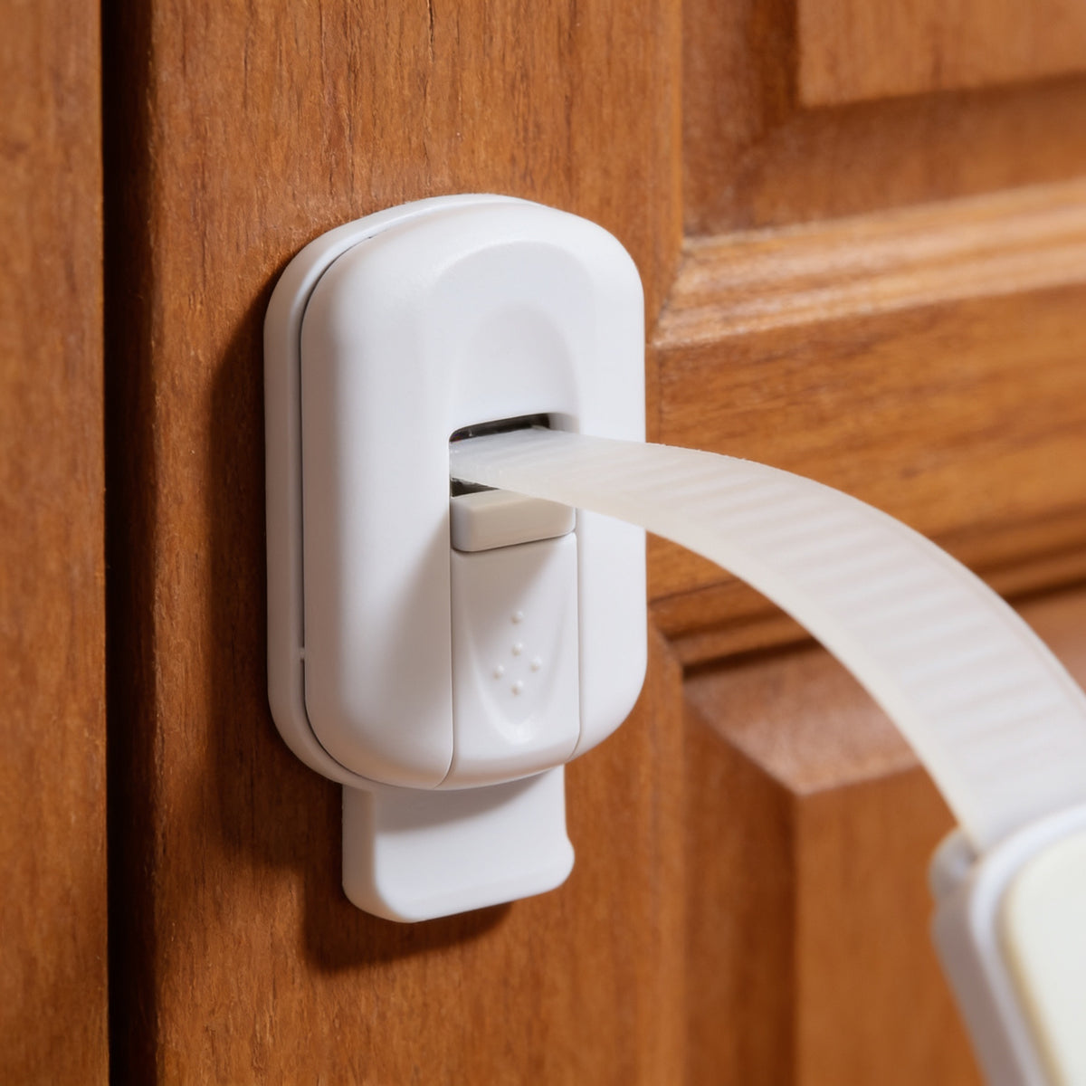 Lumiwee Adhesive cabinet and drawer strap lock: close-up of the strap lock end and slide button