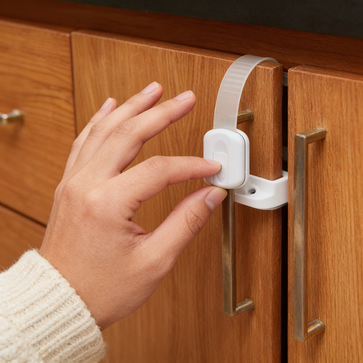 Lumiwee Adhesive cabinet and drawer strap lock: sliding the button to release the strap