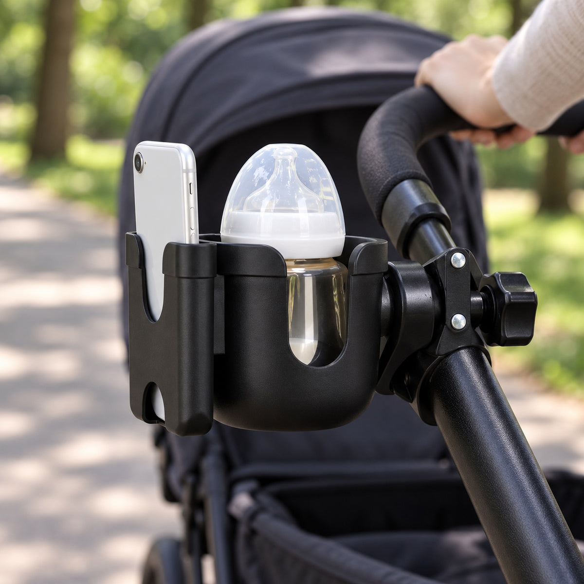 Black cup and phone holder mounted on a stroller with a capped bottle and plain phone