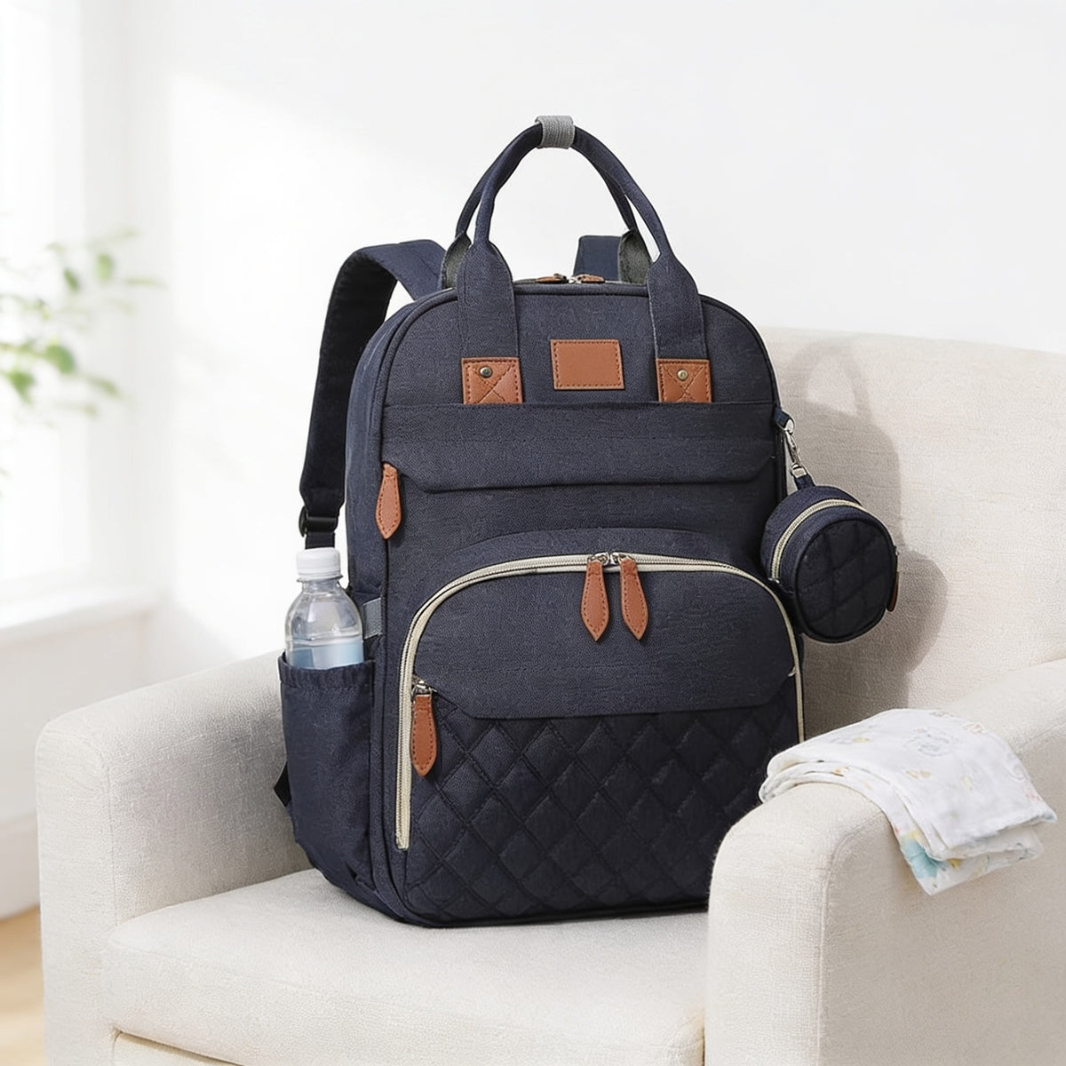 Lumiwee Swift diaper backpack: navy quilted diaper backpack on a linen armchair