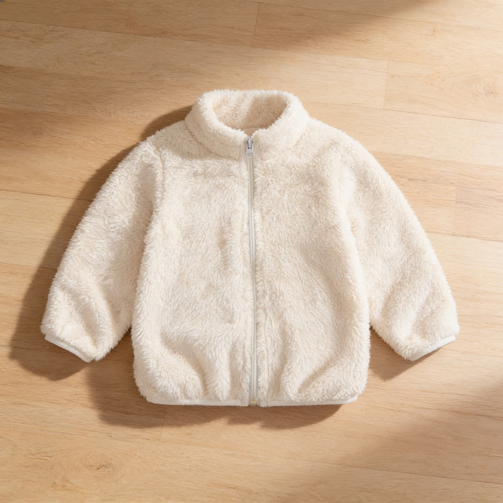 Lumiwee Teddy kids plush jacket: the cream plush jacket laid flat on a wood floor