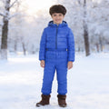 Lumiwee Tundra kids snowsuit set: child in the royal blue puffer jacket and pants set in the snow