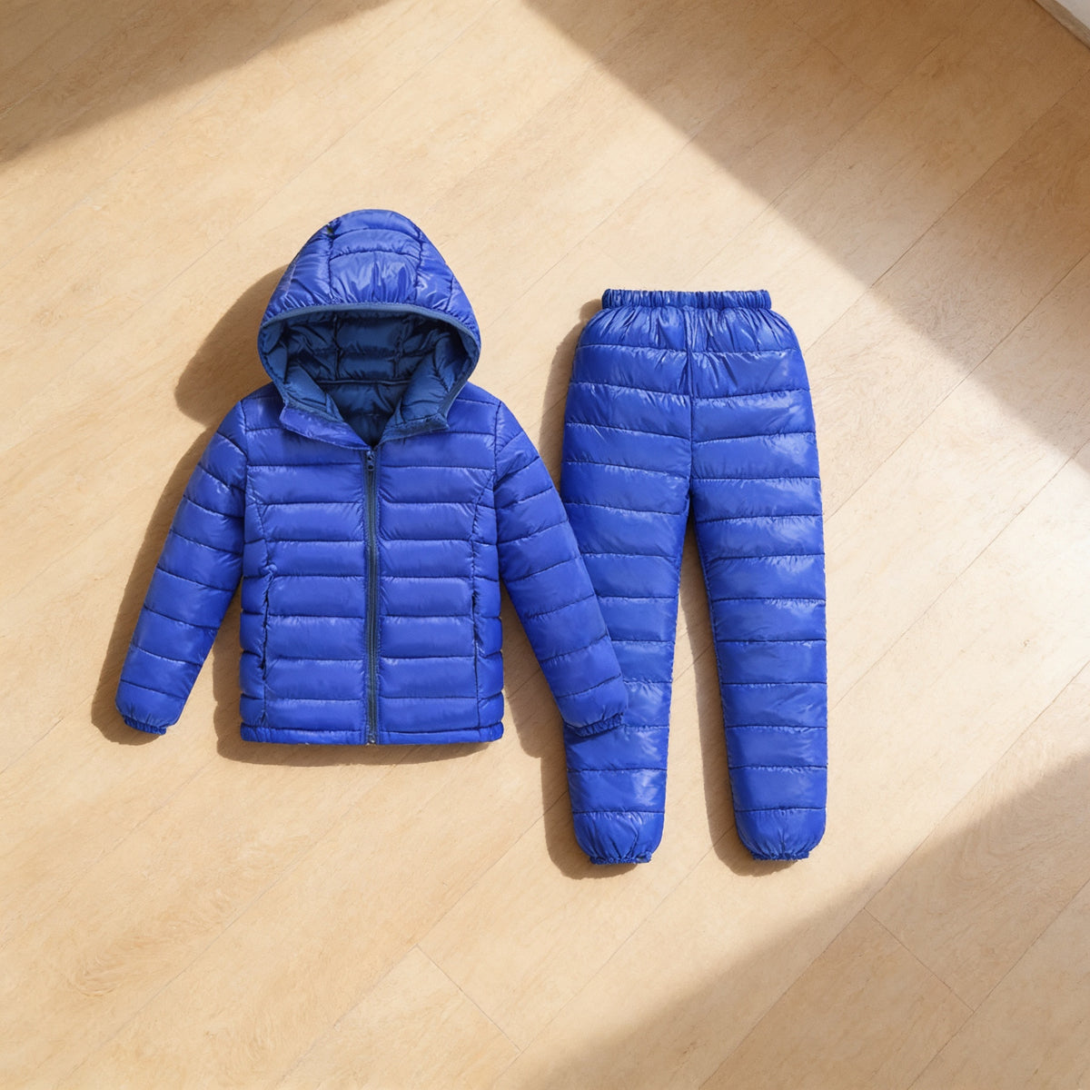 Lumiwee Tundra kids snowsuit set: the jacket and pants set laid flat on a wood floor