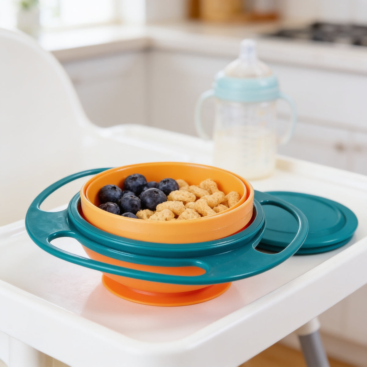 Lumiwee Twirl 360 rotating baby bowl: teal rotating snack bowl with blueberries on a high-chair tray