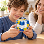 School-age child holding a Blue maze cube with parent nearby