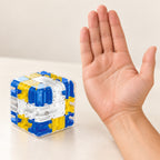 Blue maze cube beside an adult palm for scale