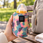 Adult holding the Pink camouflage warmer around a capped bottle outdoors