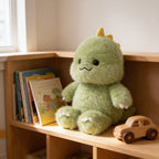 Lumiwee Waddle animal plush: green dinosaur plush on a playroom bookshelf