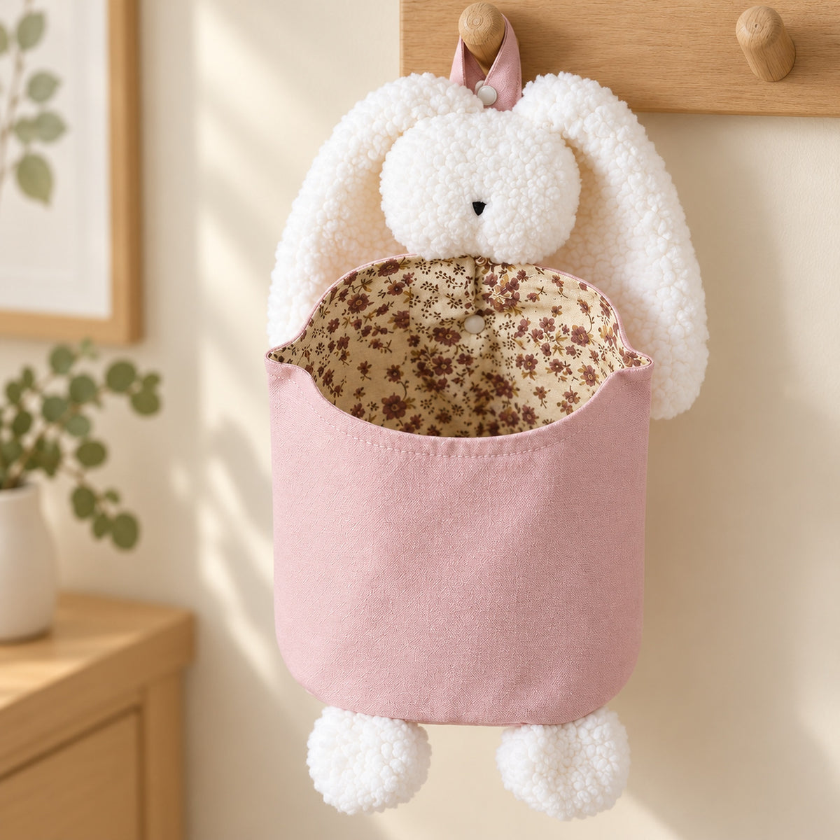 Close-up of white sherpa bunny trim and floral lining on the pink diaper pouch