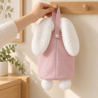 Adult placing the pink organizer's closed snap loop over a wall peg