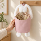 Pink bunny hanging organizer beside an adult hand for scale