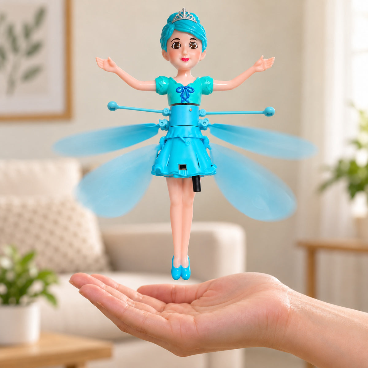 Blue flying fairy doll hovering above an adult's open palm in an uncluttered living room