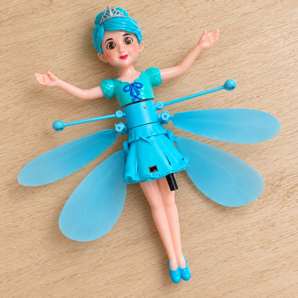 Blue flying fairy doll with stopped rotors lying on a pale wooden tabletop