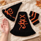 Newborn crochet witch costume set beside an adult palm for scale