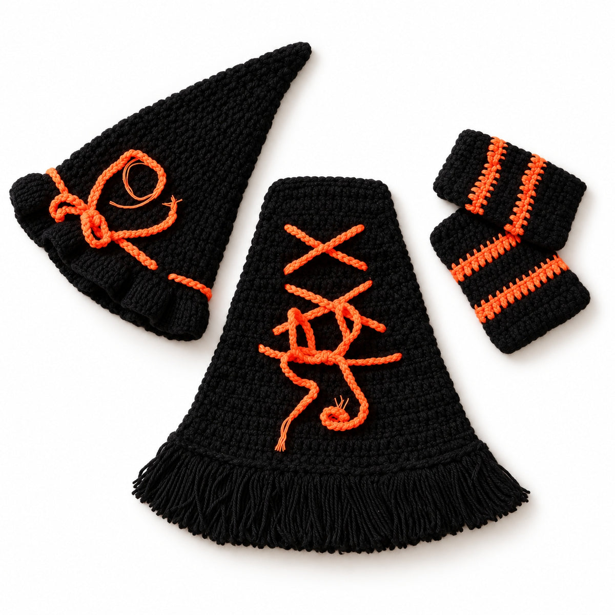 Pointed witch hat, lace-up cloak and pair of striped socks on a white background