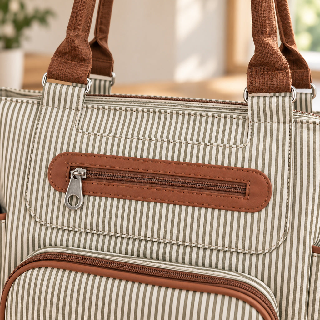 Close-up of brown zipper trim, plain metal pull and pinstripe fabric on the Khaki tote