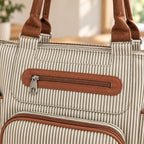 Close-up of brown zipper trim, plain metal pull and pinstripe fabric on the Khaki tote