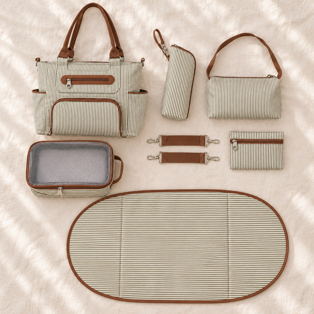 Khaki tote, four matching pouches, oval changing pad and pair of stroller straps laid out together